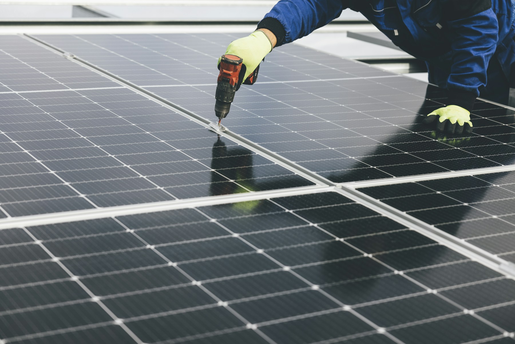 Installer working on a rooftop solar panel system
